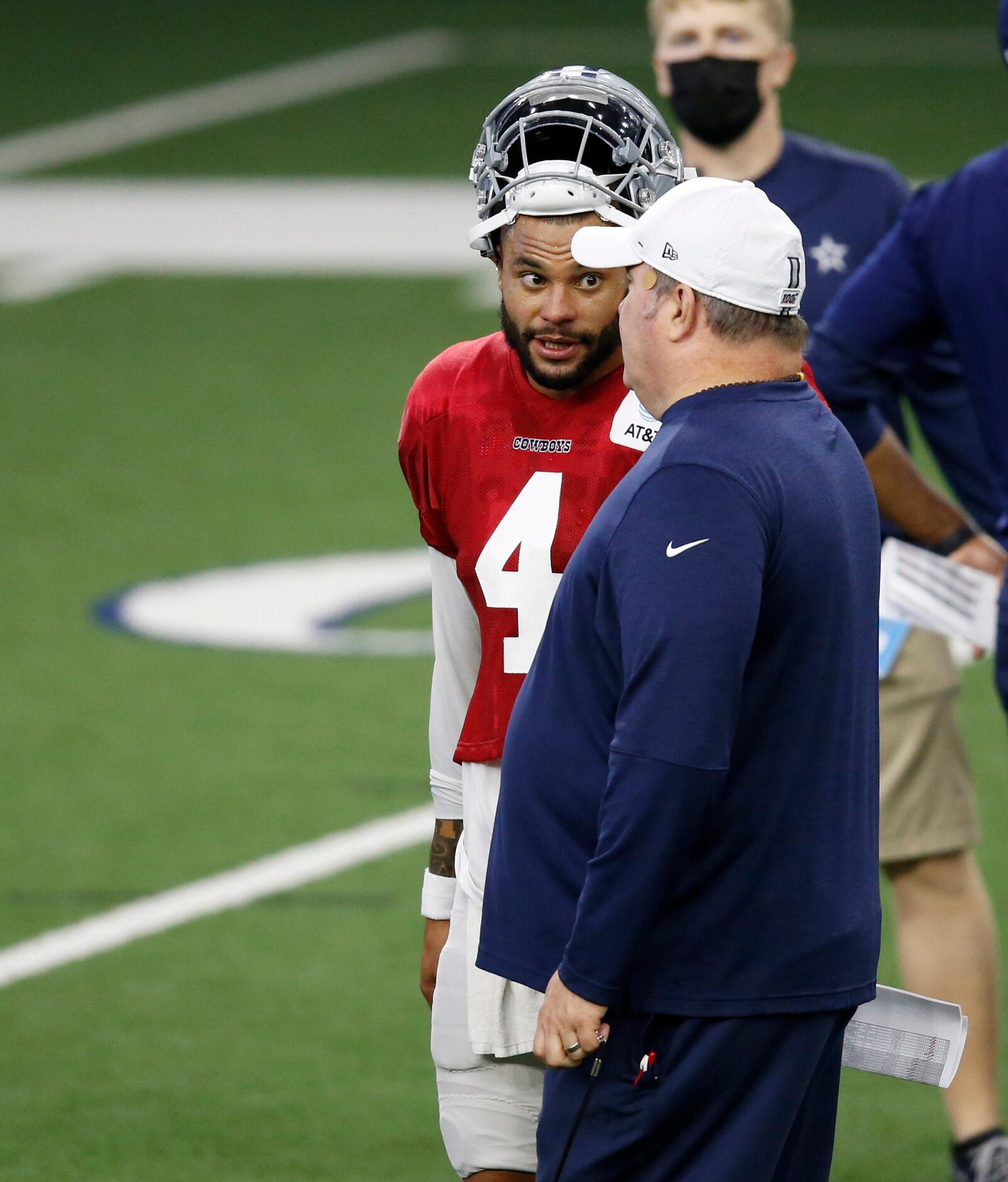 Dallas Cowboys head coach Mike McCarthy talks to Dallas Cowboys quarterback Dak Prescott (4)...