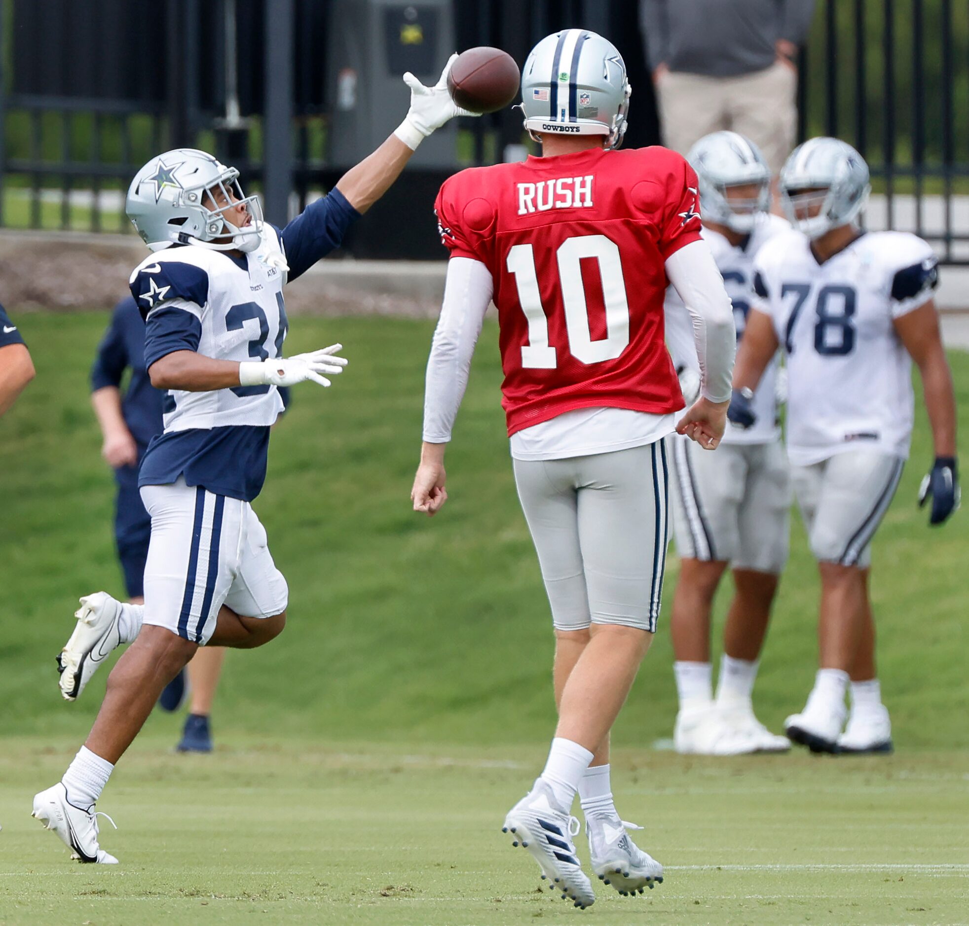 Dallas Cowboys running back Malik Davis (34) reaches for a pass from quarterback Cooper Rush...