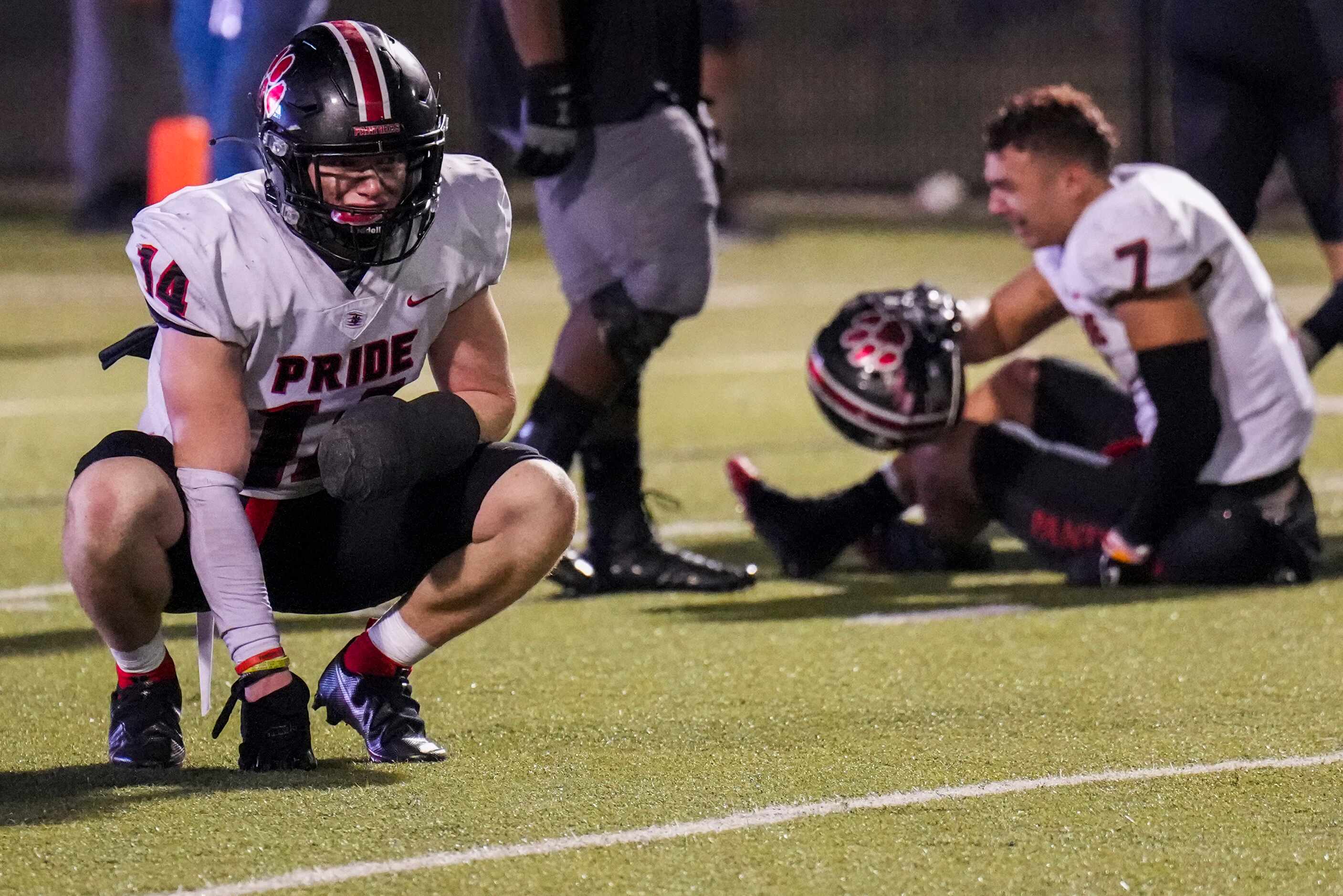 Colleyville Heritage defensive back Parker Roe (14) and linebacker Christopher Knight (7)...