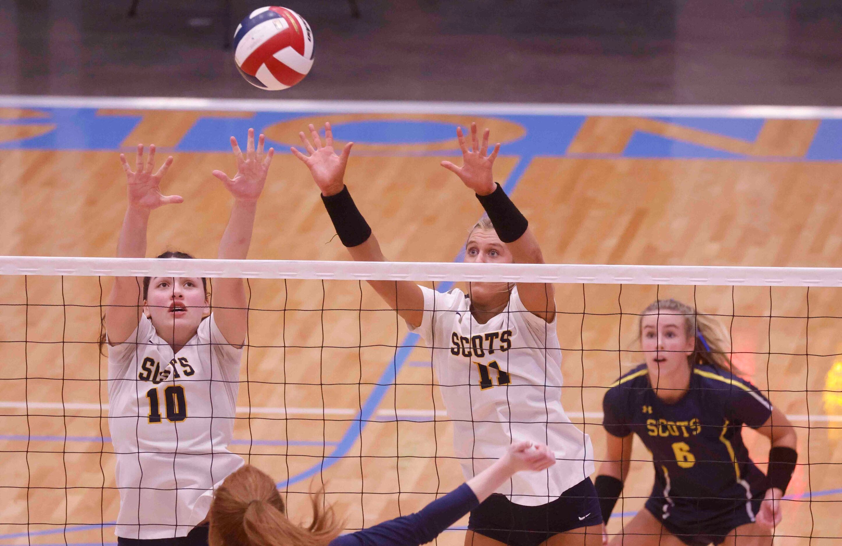 Highland Park’s Sadie Gruber (10) and Sydney Breon (11) attempt to block against Flower...