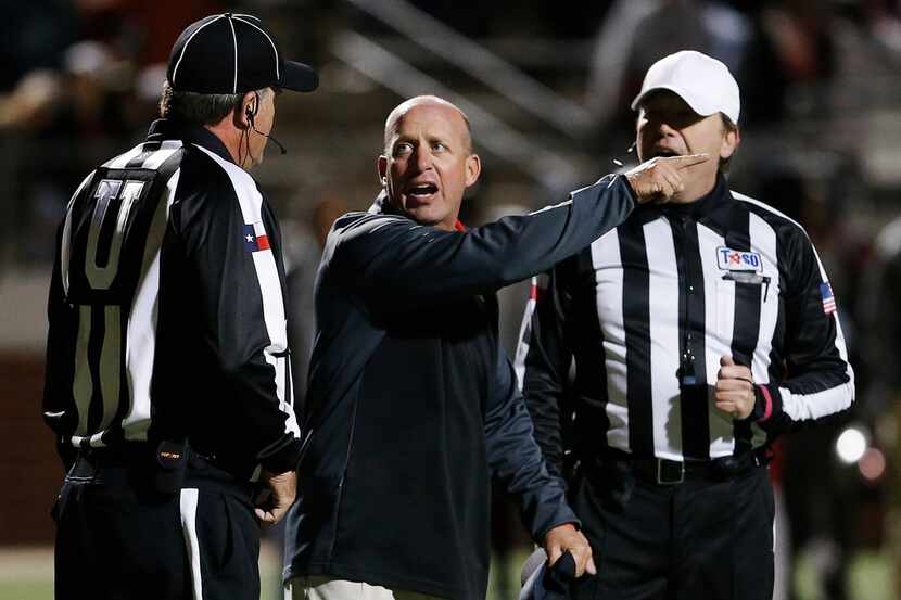 FILE - Mansfield Legacy head coach Chris Melson, center, argues a call during the second...