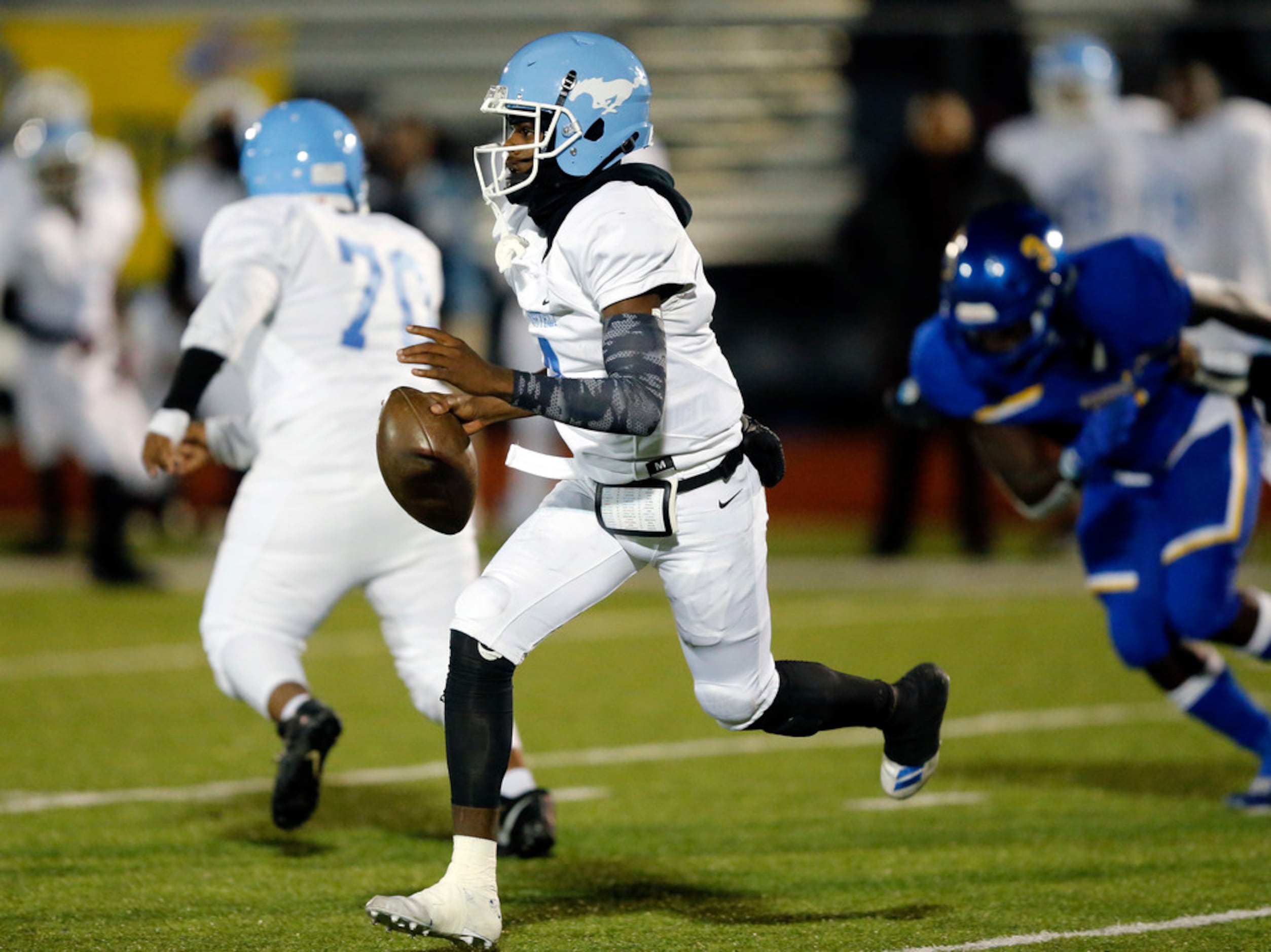 Dallas Roosevelt quarterback (4) Jowaylon Wilson rolls out looking for a receiver during the...