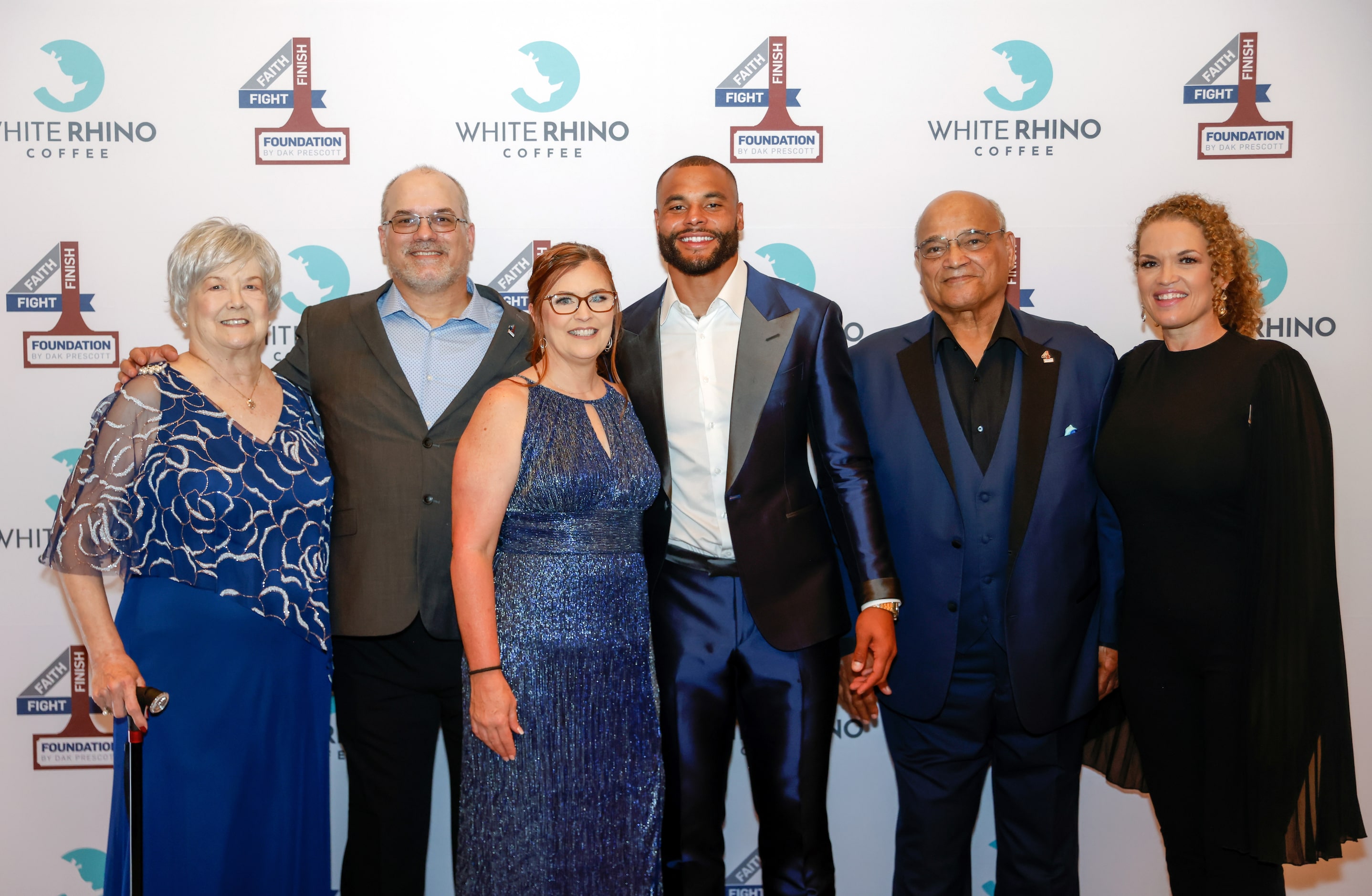 Founder and Dallas Cowboys quarterback Dak Prescott (center) poses with family and friends...