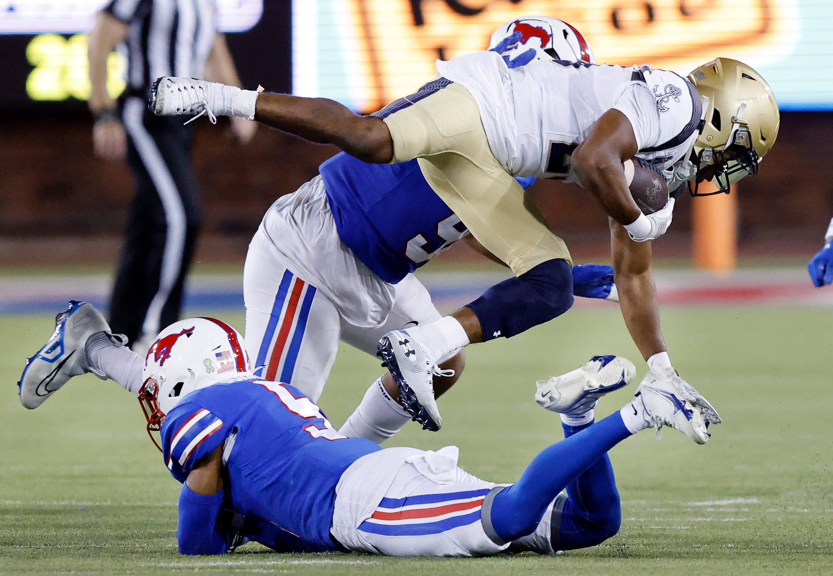 Southern Methodist Mustangs cornerback Ar'mani Johnson (5) trips up Navy Midshipmen wide...