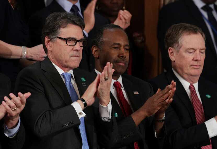 Incoming Energy Department Secretary Rick Perry (L) and Department of Housing and Urban...