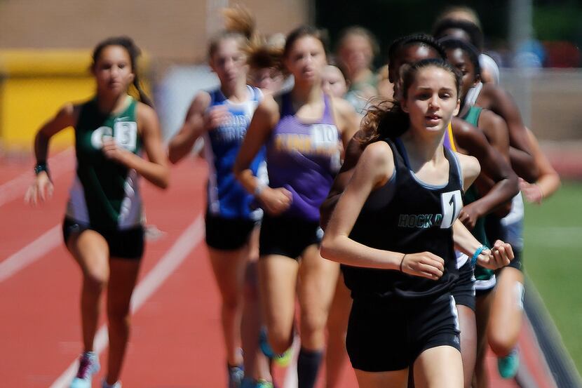 Adoette Vaughan of Hockaday leads after the first lap of the girls 800 during the final day...