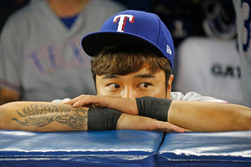 Texas Rangers right fielder Shin-Soo Choo (17) watches the Blue Jays celebrate on the field...
