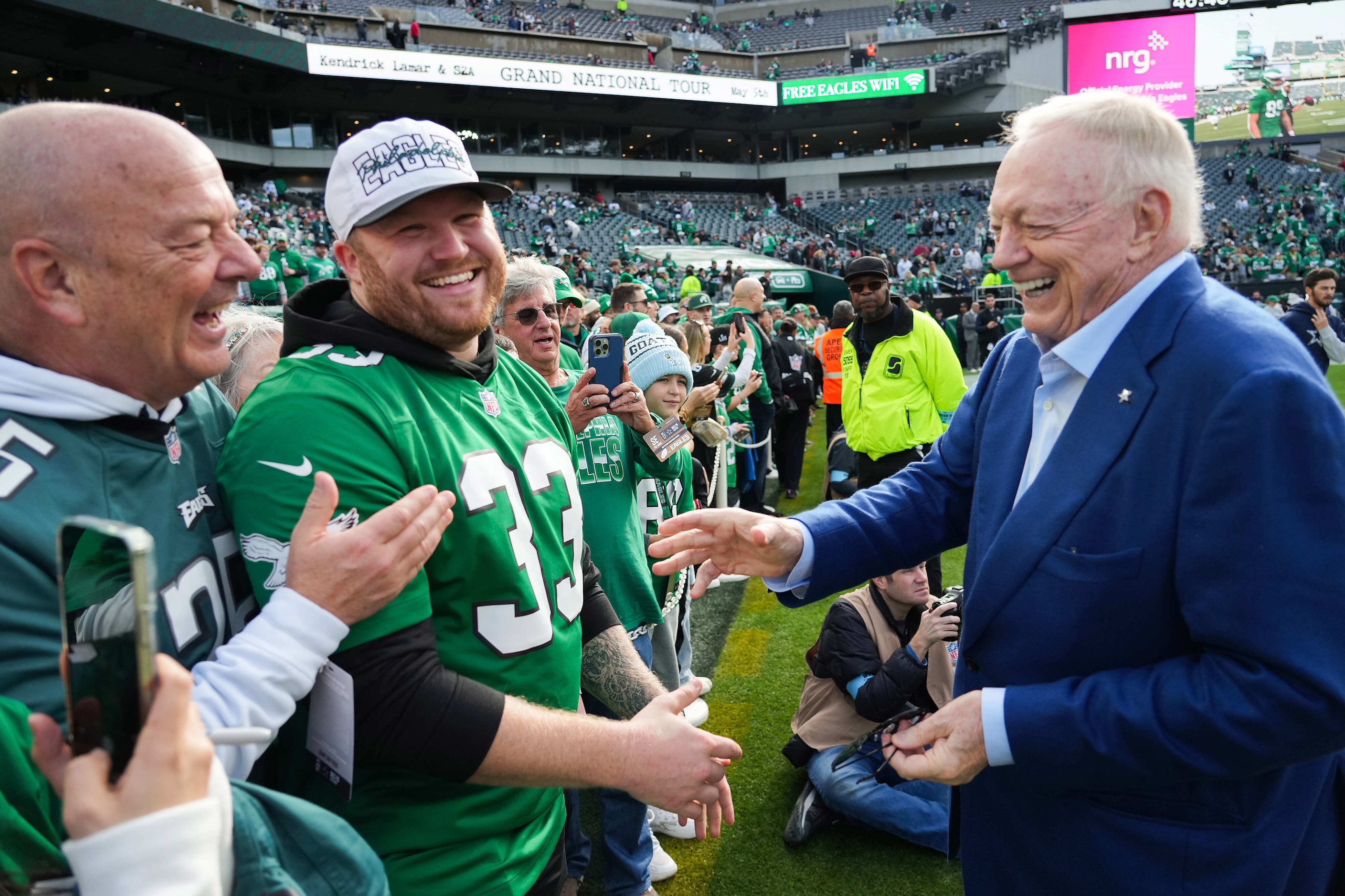 Dallas Cowboys owner and general manager Jerry Jones laughs with Philadelphia Eagles fans...