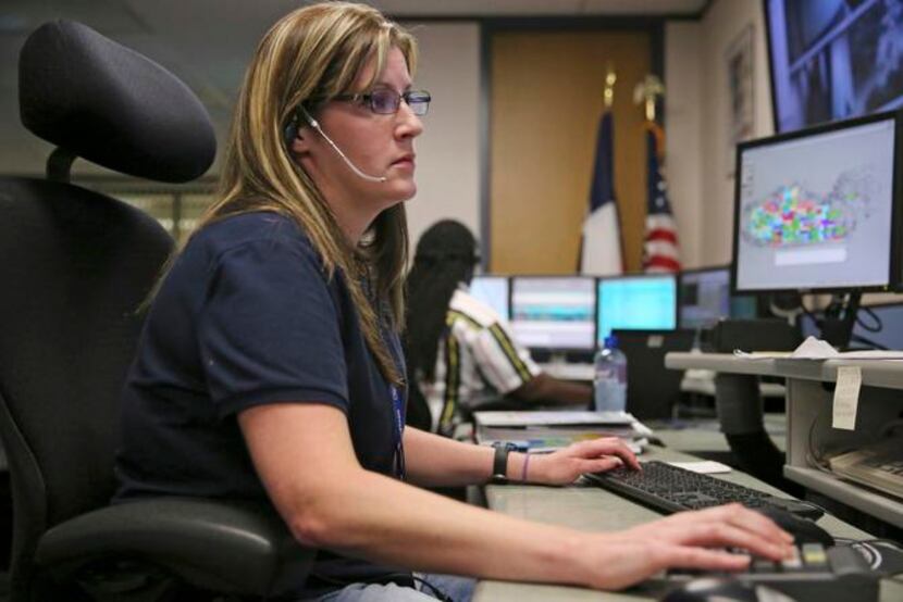 
Call taker Gina Liebert of Richardson listens to a 911 caller from the dispatch center in...
