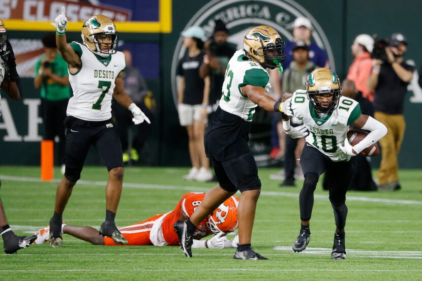 DeSoto’s Caimon Mathis (1) celebrates his interception  with London Maston (23) and Kam’ron...