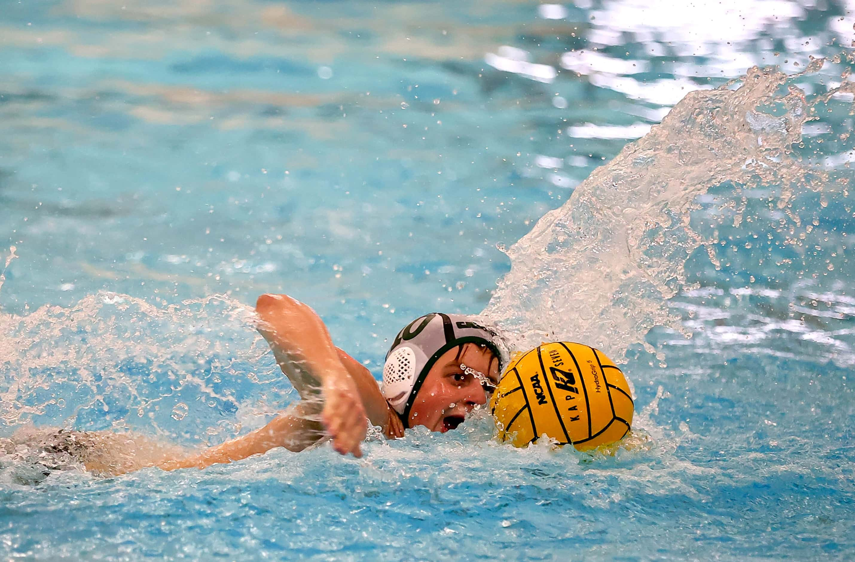 Southlake Carroll's Carter Smith swims with ball against Flower Mound Marcus in the 6A...