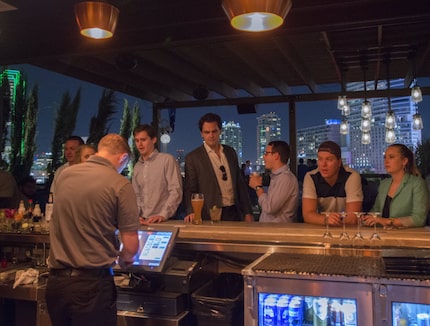 Patrons at the rooftop bar at Happiest Hour