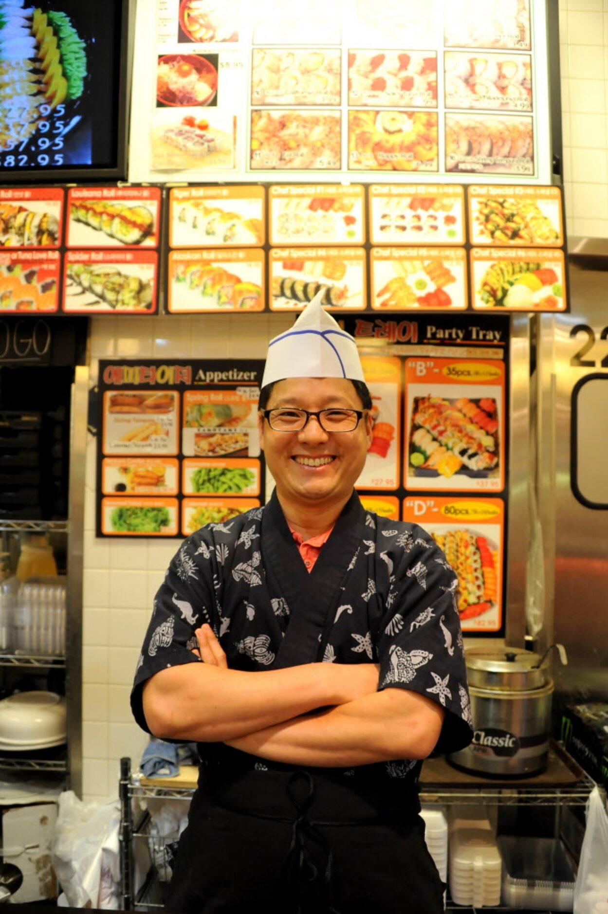 Chef Michael Wee of Sushi and Roll provides food for shoppers in the food court at H Mart in...