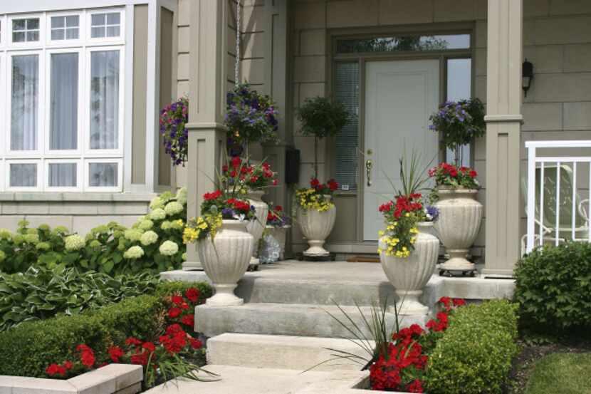 To increase a home's curb appeal, position symmetrical arrangements of plants on each side...