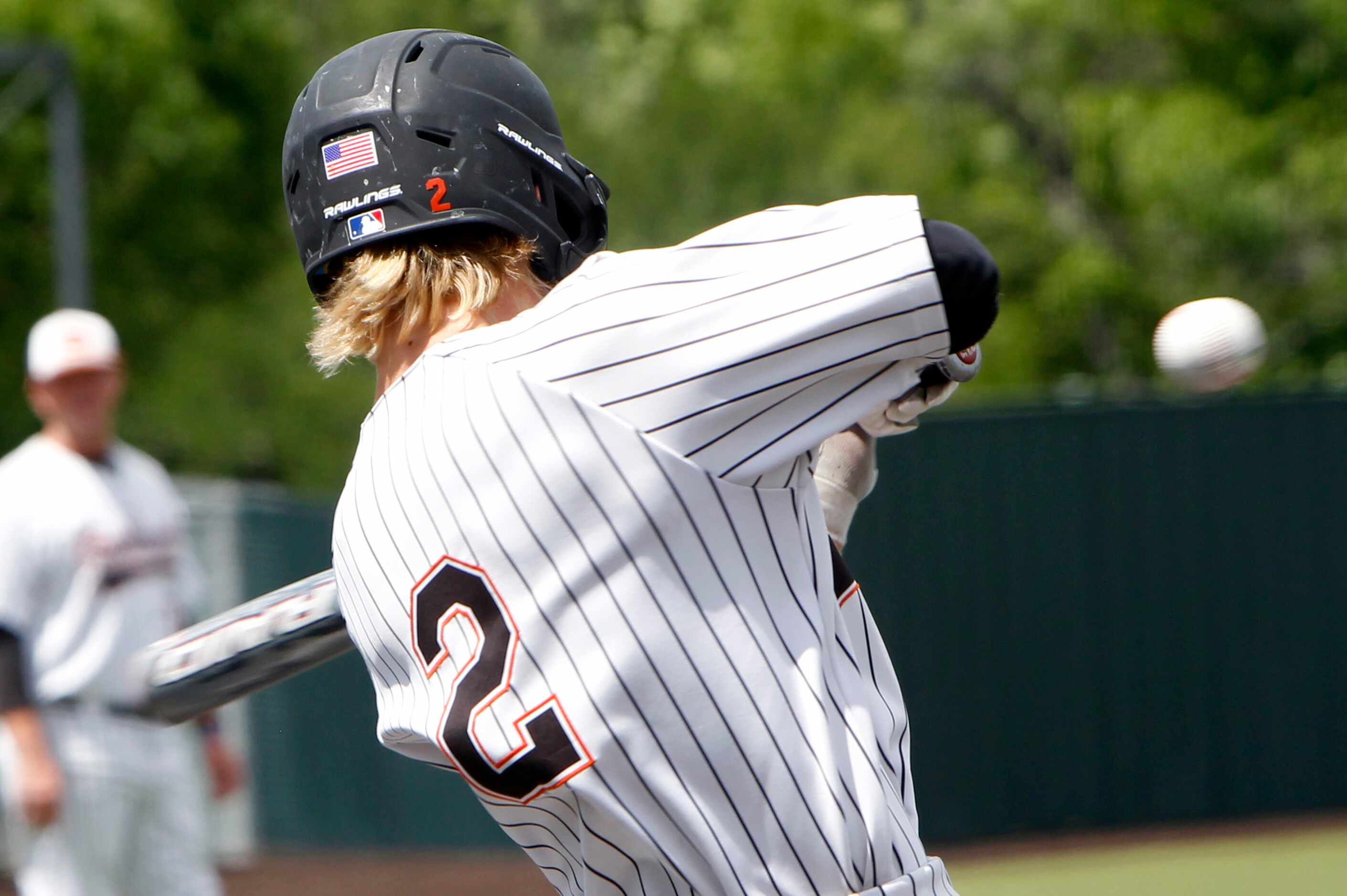Rockwall shortstop Brayden Randle (2) drives in a run with this swing of the bat during the...