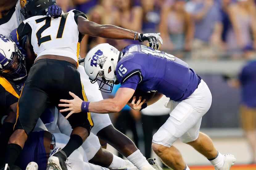 TCU Horned Frogs quarterback Max Duggan (15) ducked under Arkansas-Pine Bluff Golden Lions...