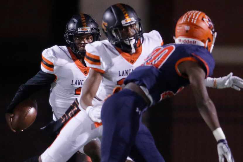 Lancaster quarterback Glenn Rice Jr. (3) follows a block from receiver LD Fair (10) against...