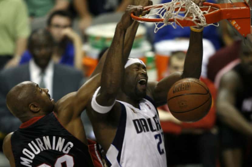 Dallas' Erick Dampier (25) dunks over Alonzo Mourning (33) during the second half of Game 2...