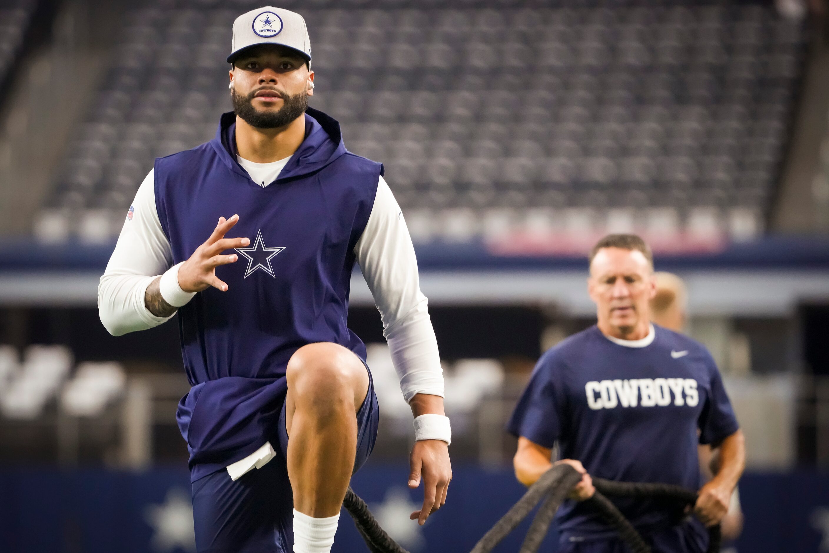 Dallas Cowboys quarterback Dak Prescott warms up before an NFL football game against the...