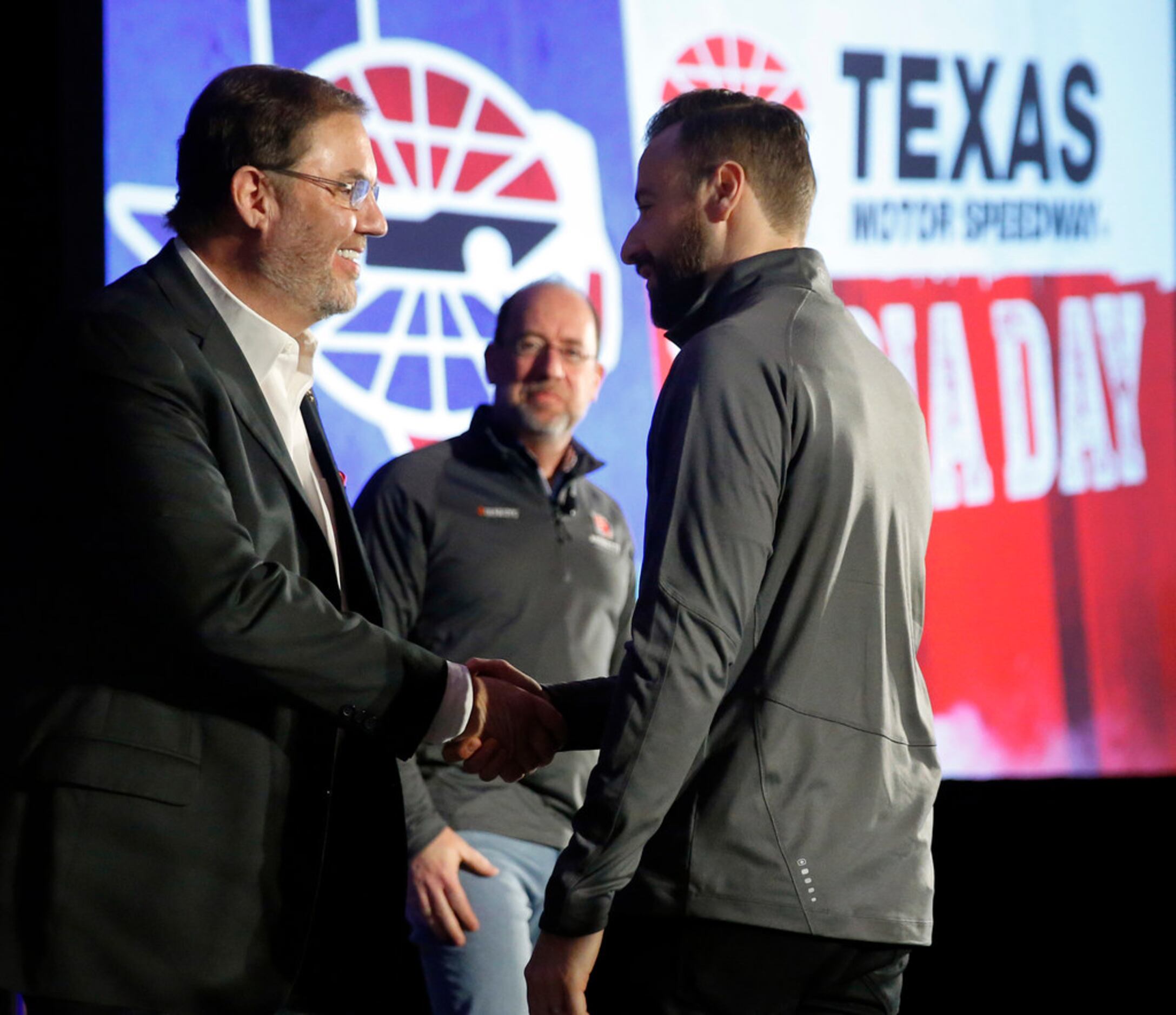 Texas Motor Speedway president Eddie Gossage  (left) thanks IndyCar Series driver James...