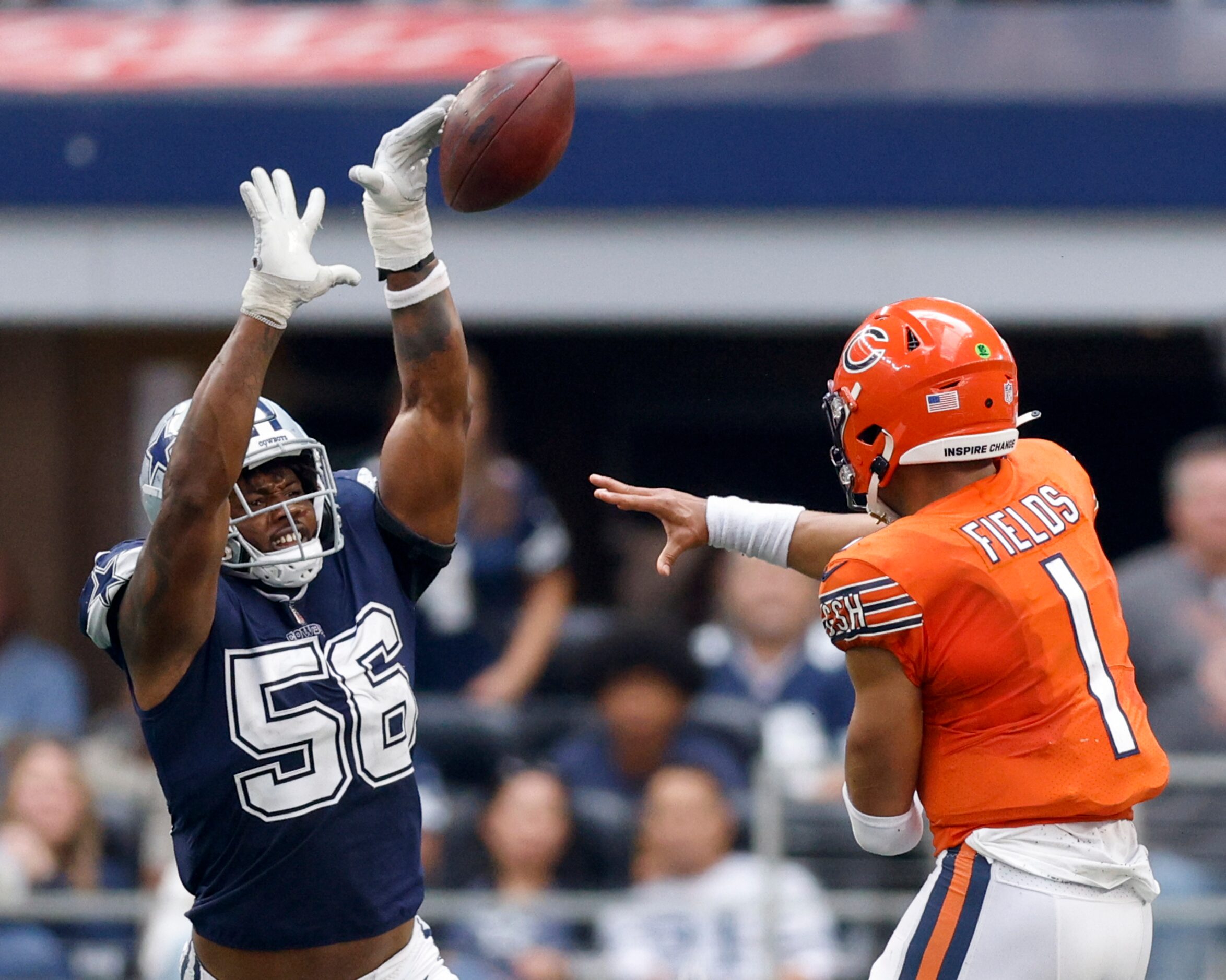 Dallas Cowboys defensive end Dante Fowler Jr. (56) jumps to block a pass from Chicago Bears...