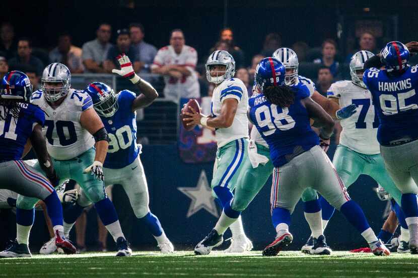 Dallas Cowboys quarterback Dak Prescott (4) looks for a receiver during the fourth quarter...
