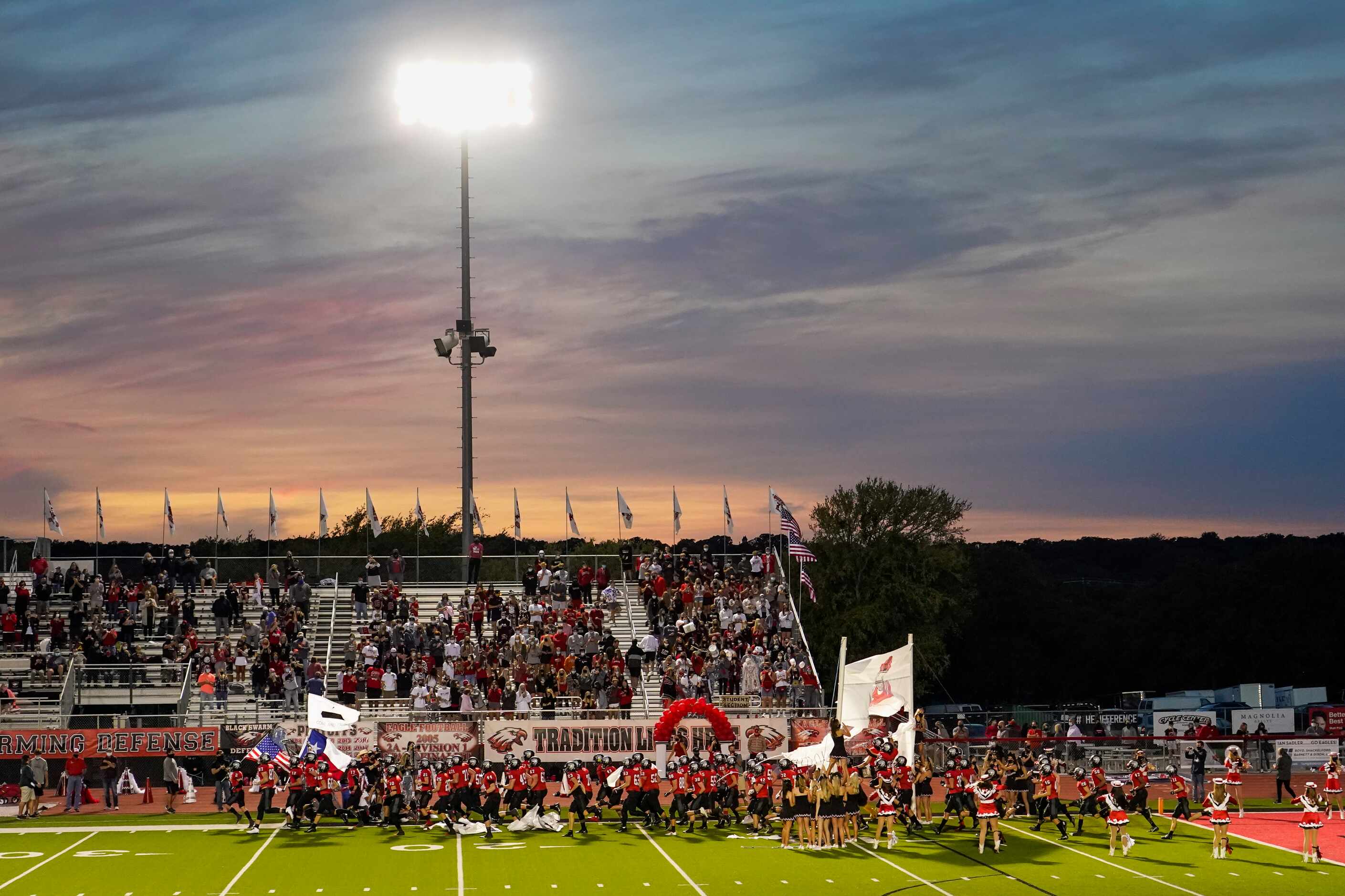 The Argyle Eagles take the field as the sun sets before a high school football game against...