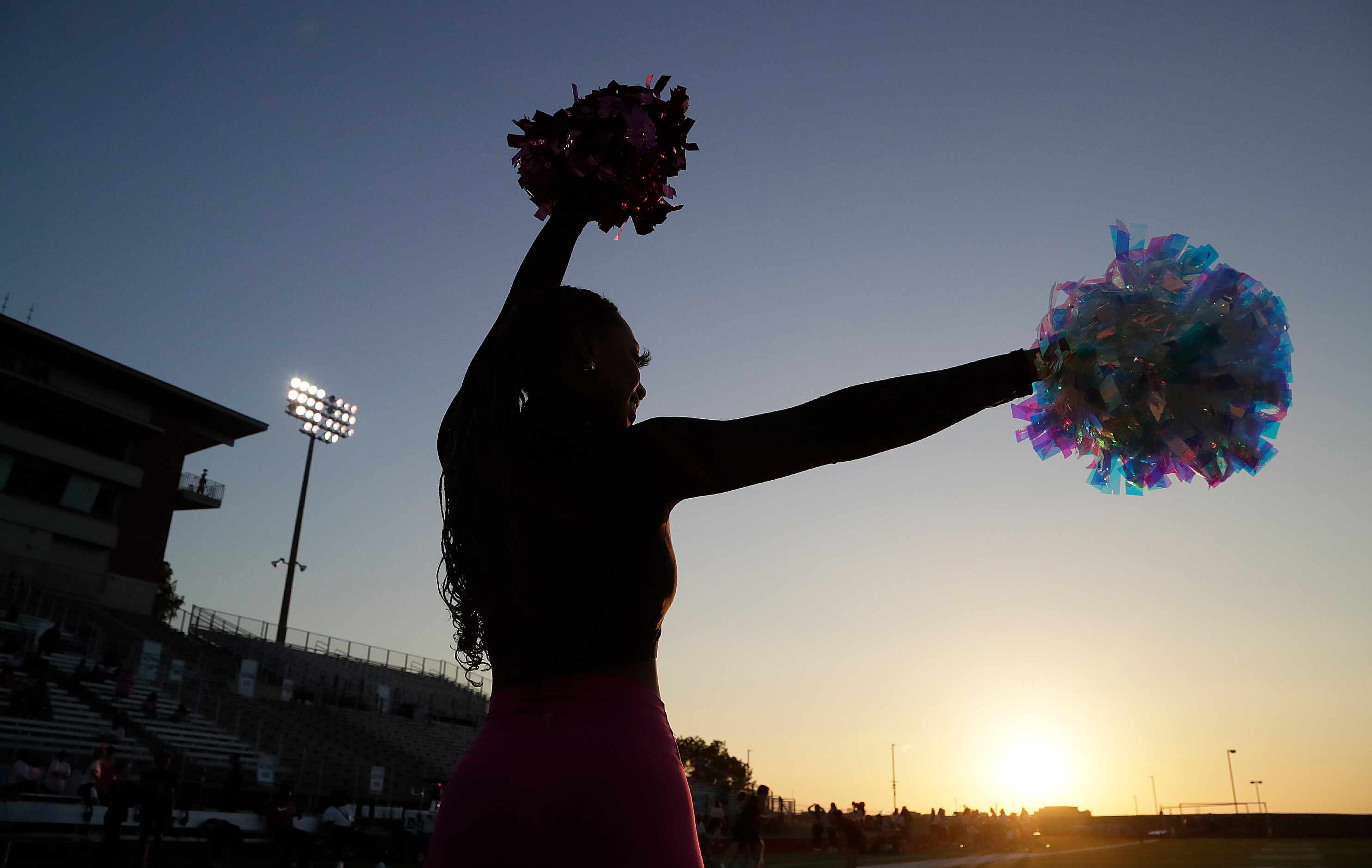 Kaitlin Phillips, 17, with the Frisco Heritage High School High Steppers awaits the players...