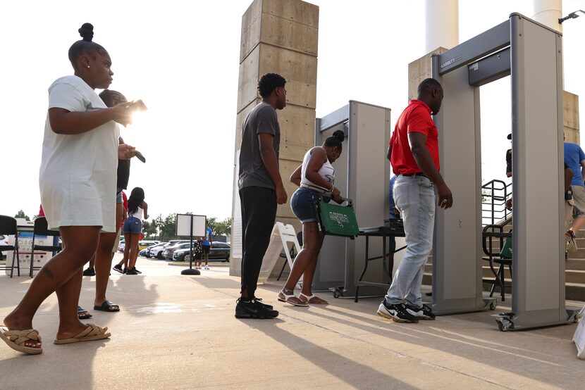 People prepared to walk through metal detectors to enter to Standridge Stadium in Carrollton...