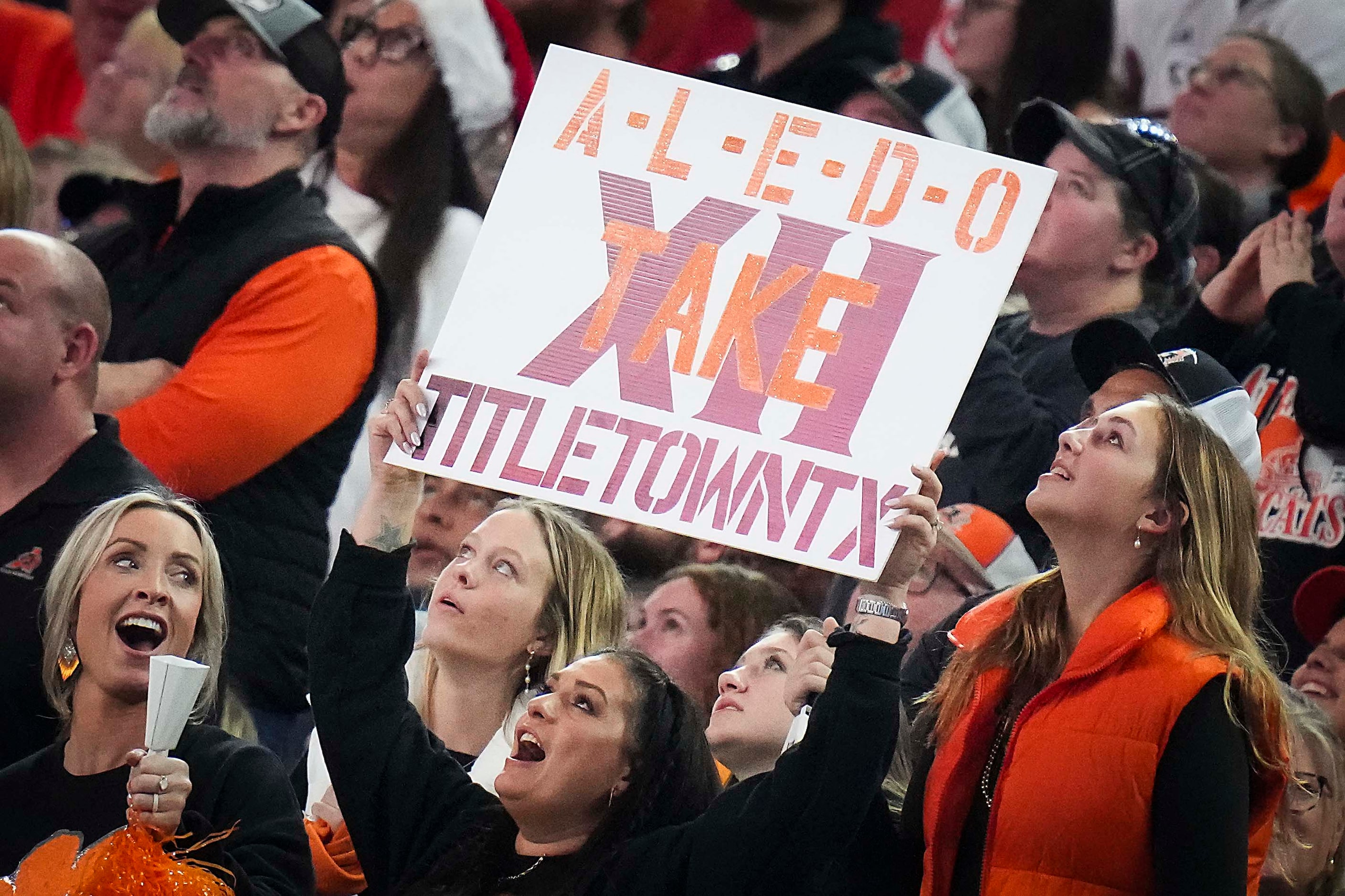 Aledo fans hold a sign cheering the Bearcats to their 12th championship during the second...