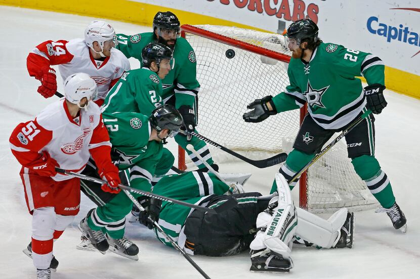 Dallas Stars defenseman Stephen Johns (28) uses his hand to clear the puck away from the...