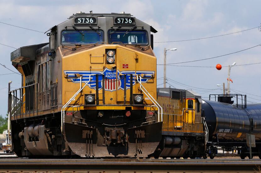 FILE - In this June 6, 2014, file photo, Union Pacific locomotives pull a train in Council...