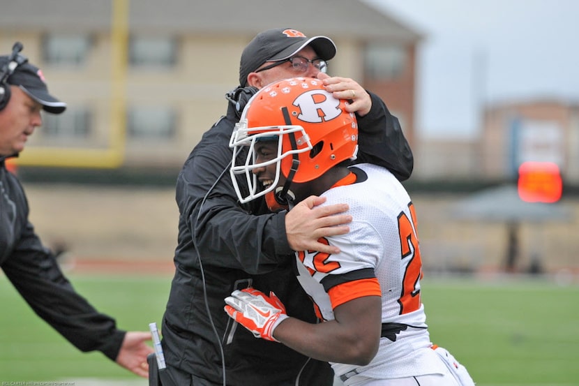 Rockwall coach Rodney Webb congratulates A.J. Blacknall (22) after a 48-27 win over Jesuit.