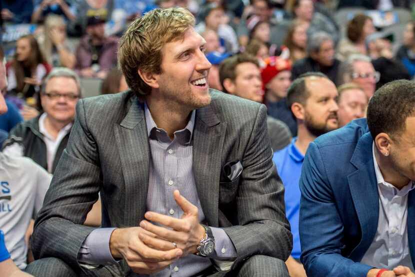 Injured Dallas Mavericks forward Dirk Nowitzki (41) watches from the bench during the first...