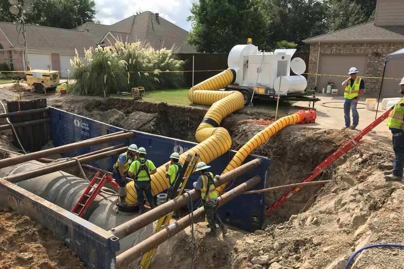 Workers repair a water pipeline that broke in Richardson on Thursday. It was back in service...