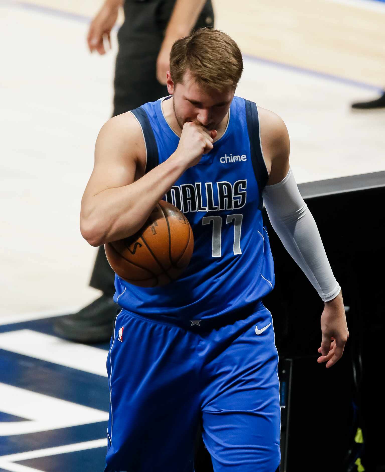 Dallas Mavericks guard Luka Doncic (77) holds back arguing a call during the first half of...