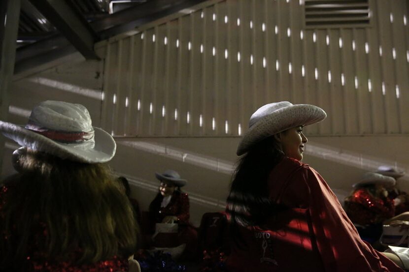 McKinney Boyd Bailadoras member Maricela Frias sits with teammates during a weather delay as...