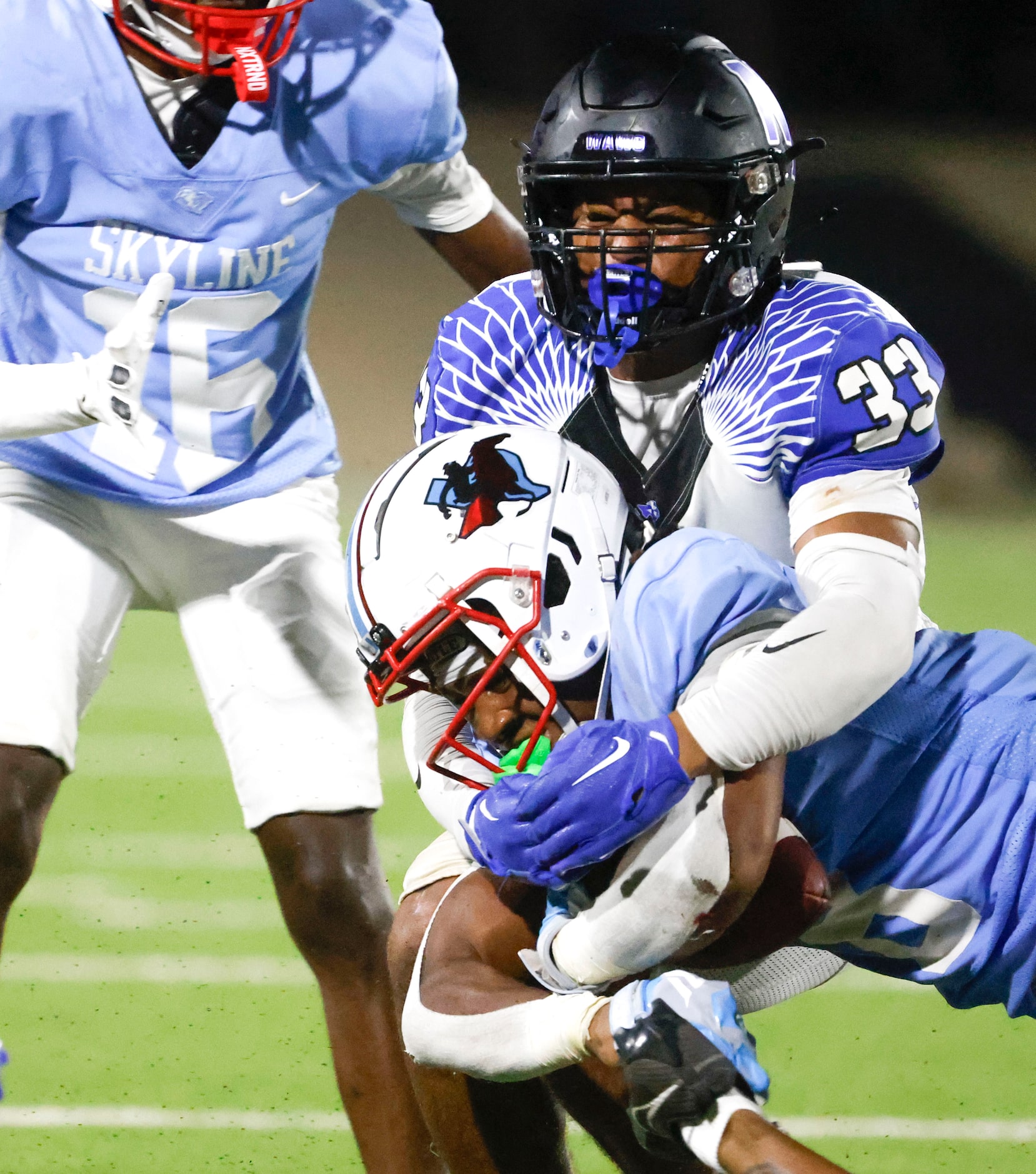 North Forney High’s Jackson Van Otten (33) tackles Skyline High’s Tyreke Cockroft during the...