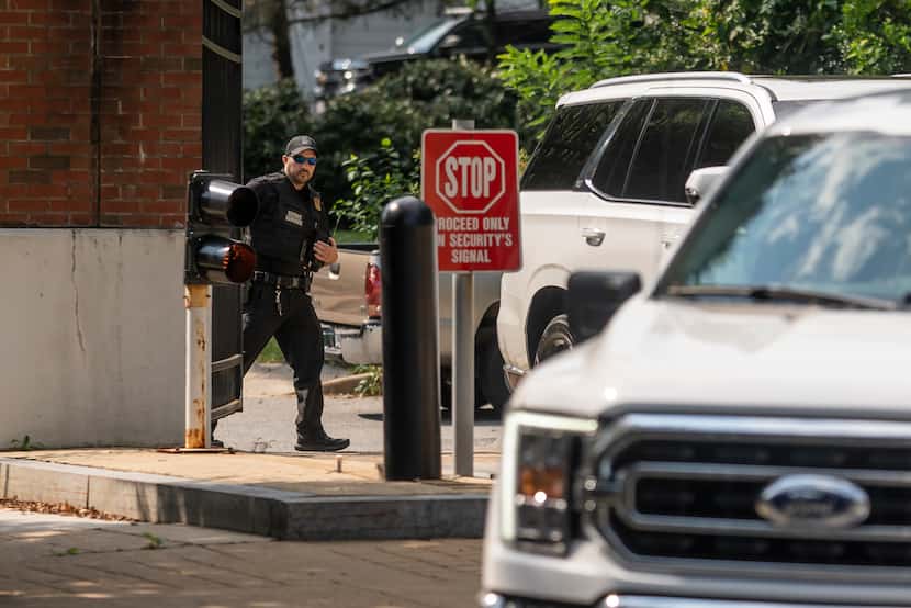 A member of the U.S. Secret Service closes a security gate near the Vice President's...