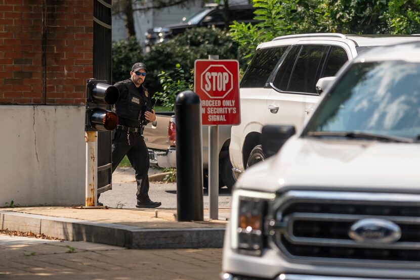 A member of the U.S. Secret Service closes a security gate near the Vice President's...