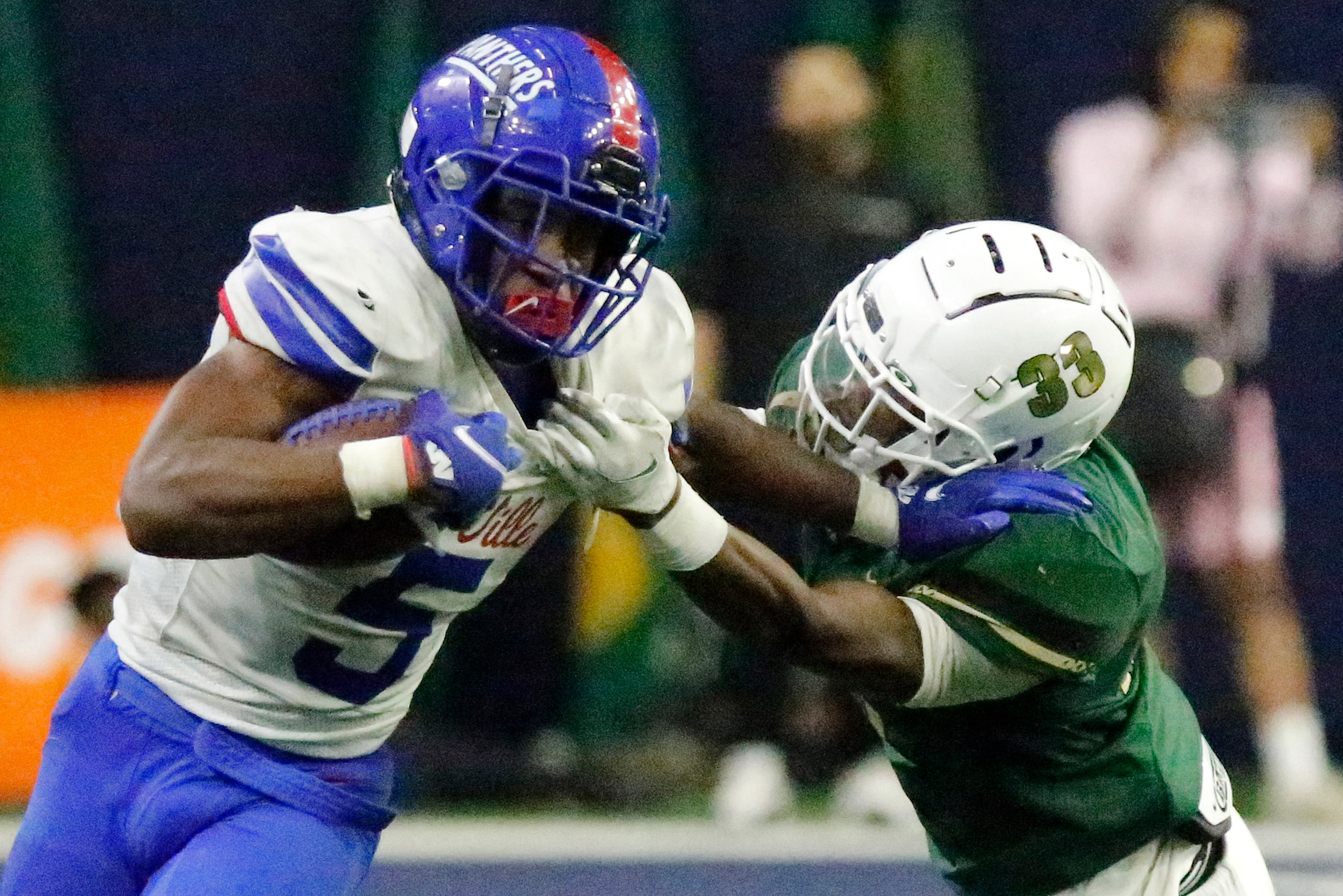 Duncanville High School running back Malachi Medlock (5) tries to stiff arm DeSoto High...