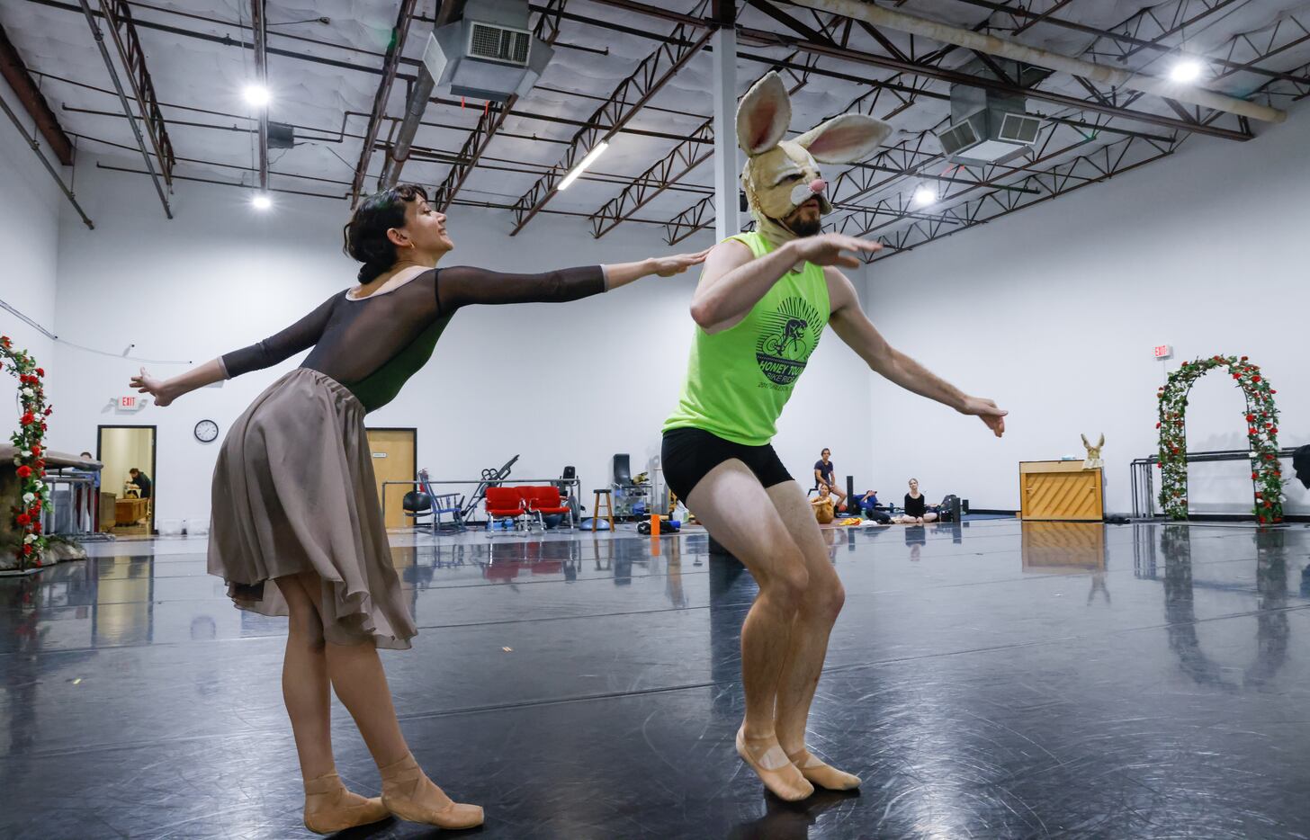 Alexandra F. Light (left) taps the shoulder of her cast-mate as they rehearse the Texas...