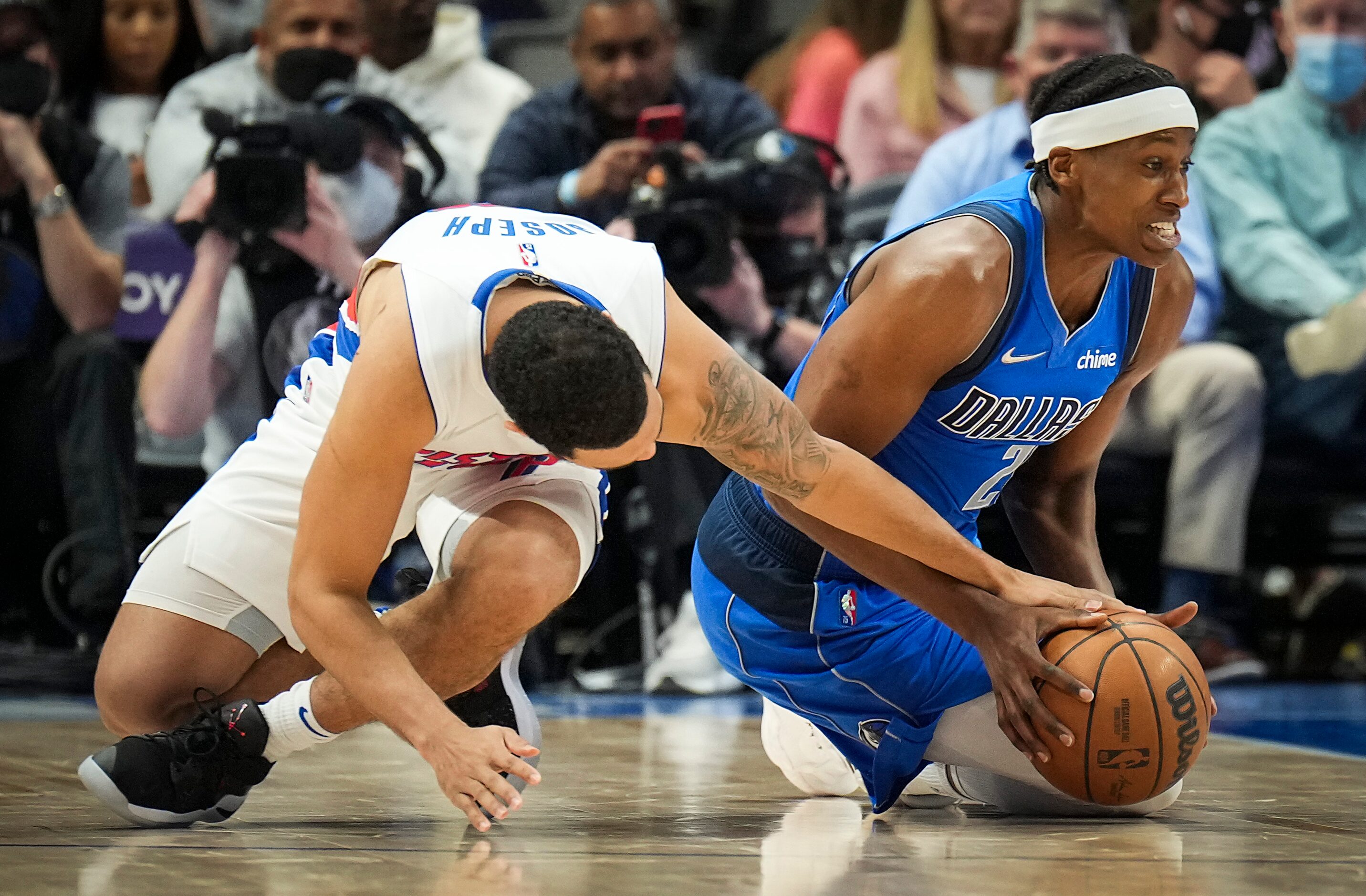 Dallas Mavericks guard Frank Ntilikina (21) fights for a loose ball against Detroit Pistons...