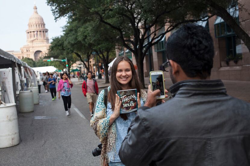 Yulia Dyukova has her photo taken by Isuru Fernando on Congress Avenue in Austin during the...