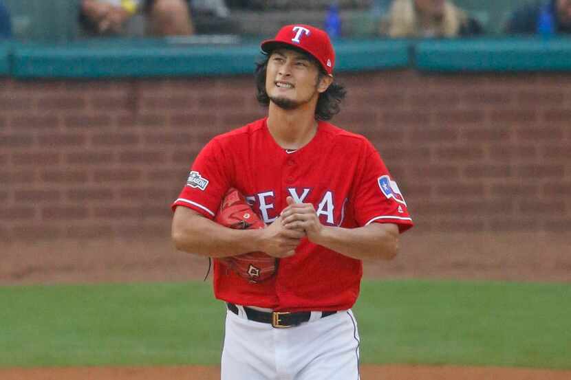 Texas Rangers starting pitcher Yu Darvish (11) reacts after giving up a two-run homer to...