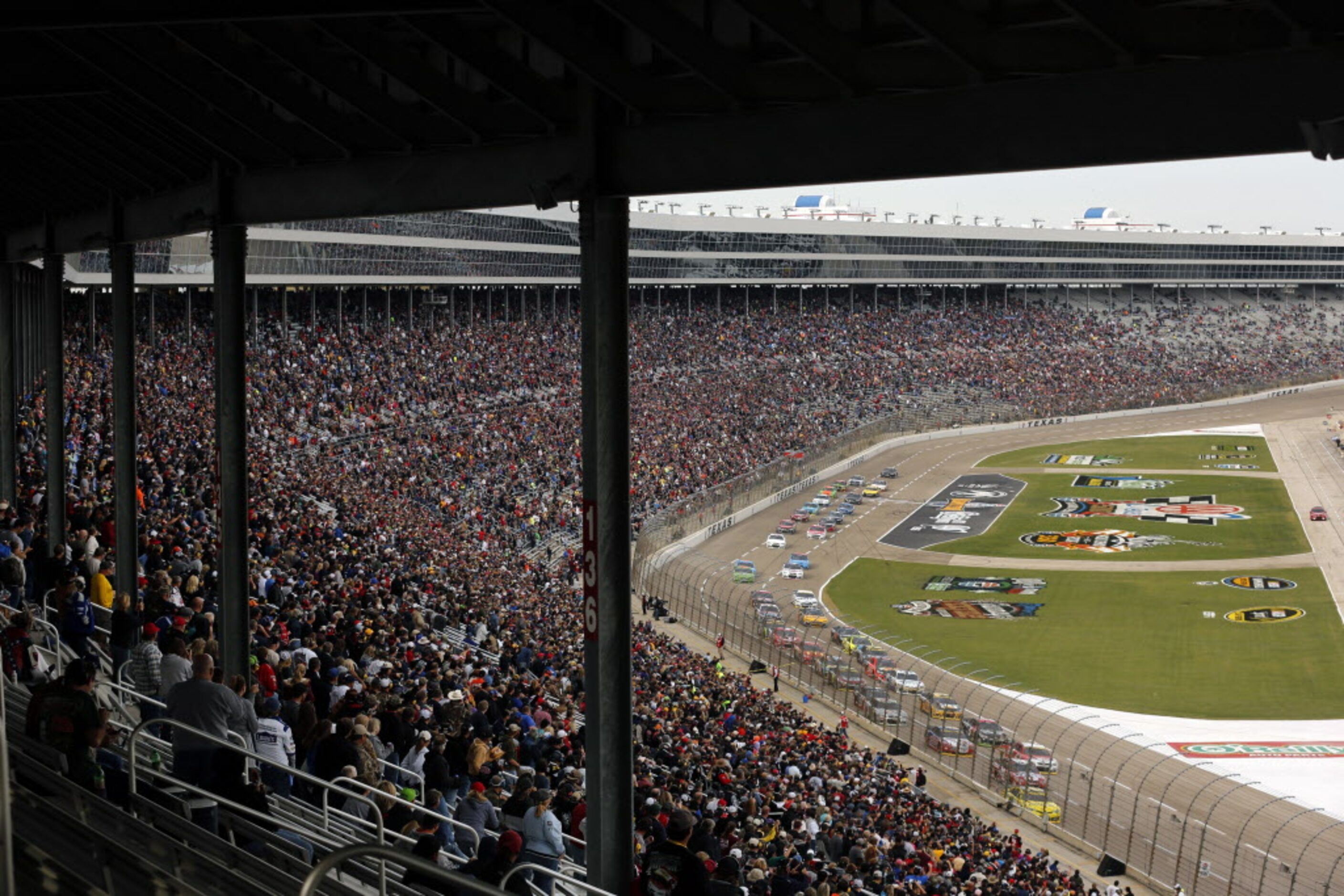 The field of cars race down the front stretch on a restart of  the AAA Texas 500 at the...