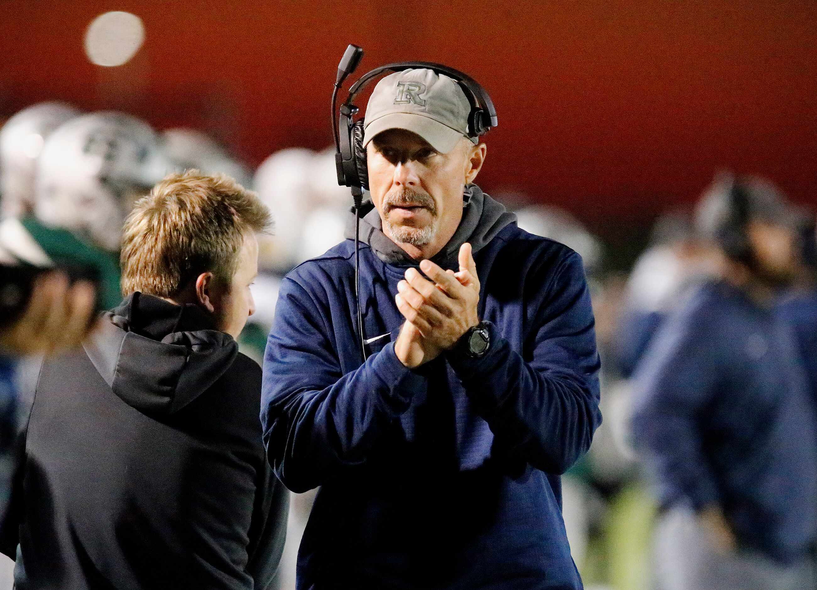 Frisco Reedy High School head coach Chad Cole applauds his teams play as Reedy High School...