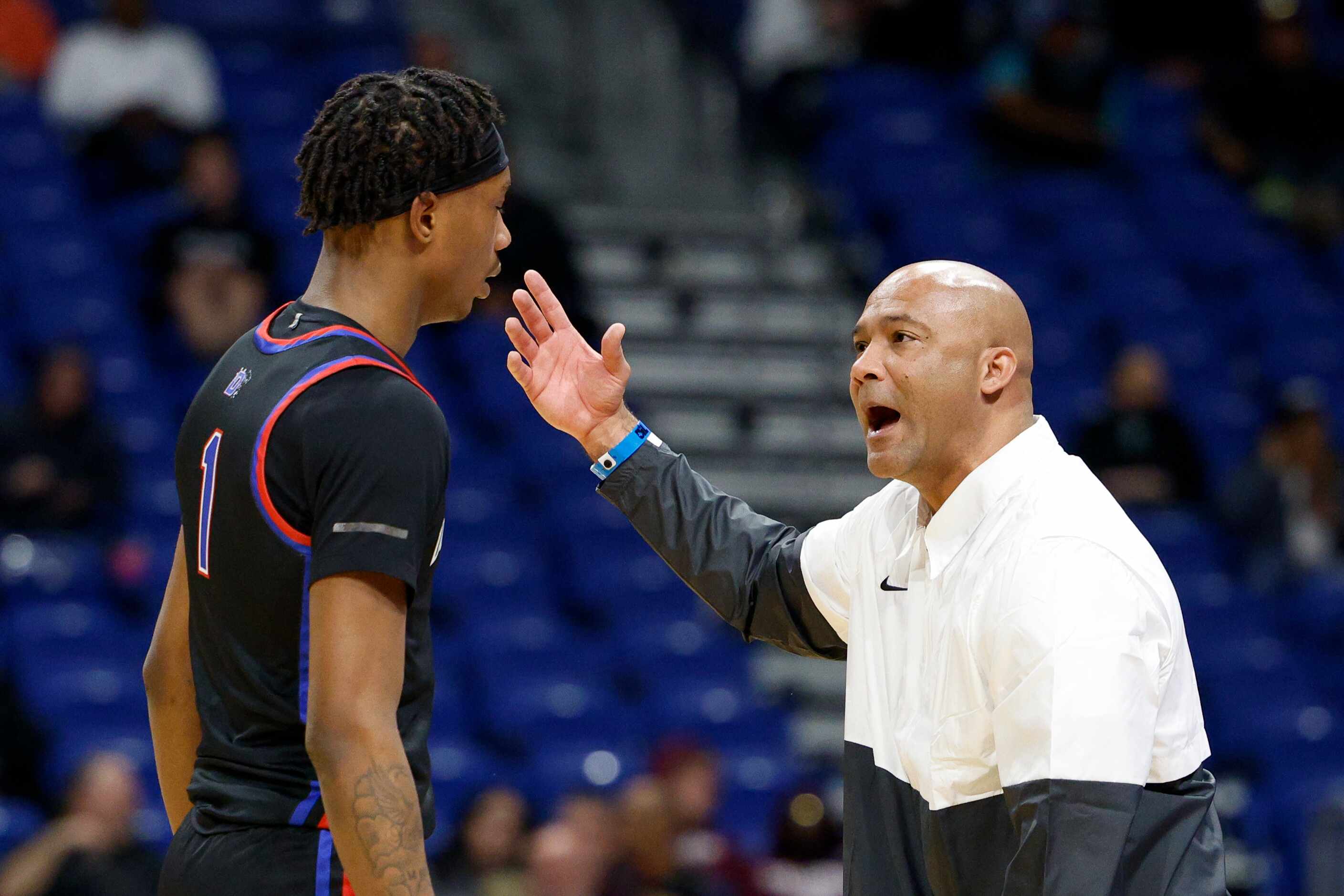 Duncanville head coach David Peavy talks with Duncanville forward Ron Holland (1) during the...