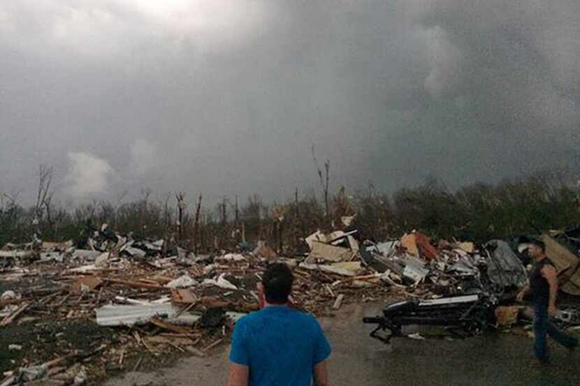 A man surveys the damage Sunday in Mayflower, Ark., after a tornado carved a path of...