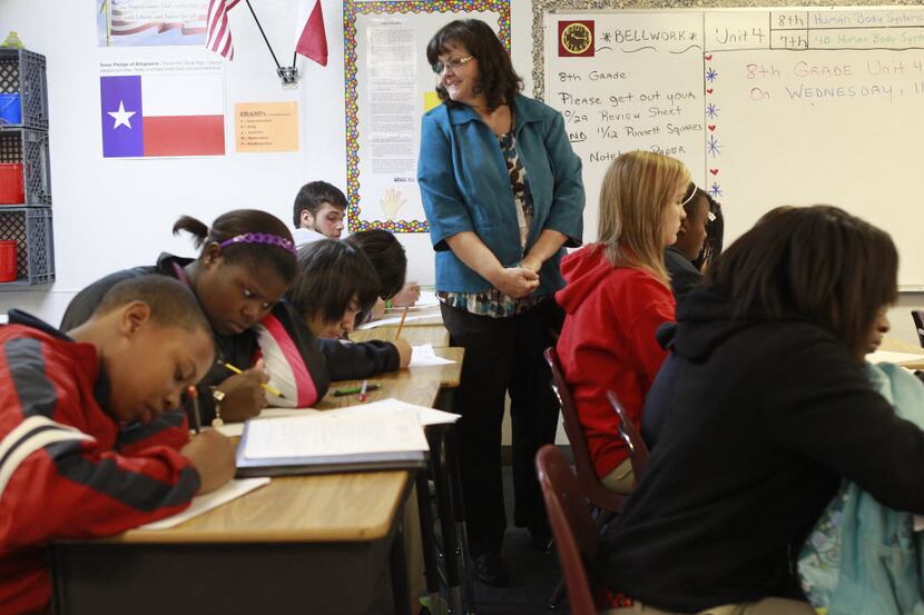 Debra Dickinson oversees eighth-graders in science class at Advantage Academy's Dallas...